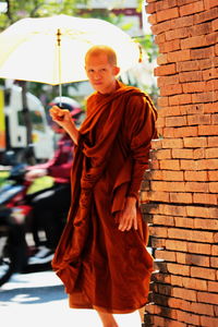 Full length of man standing against wall