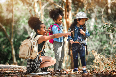 Cute girls standing in forest