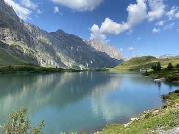 Scenic view of lake and mountains against sky