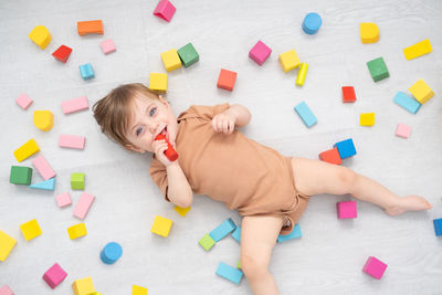 Directly above shot of baby lying amidst toys