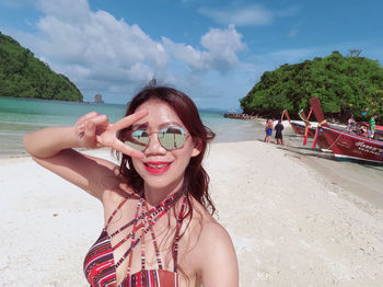 Thale waek krabi unseen krabi portrait of young woman wearing sunglasses while standing at beach 