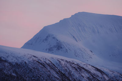 Scenic view of snowcapped mountains against sky during sunset