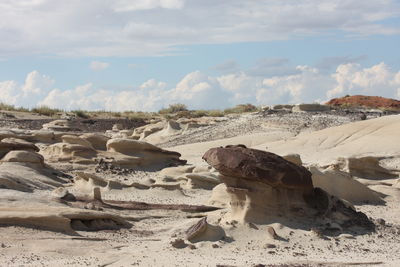 View of desert against cloudy sky