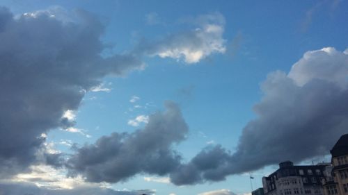 Low angle view of building against cloudy sky