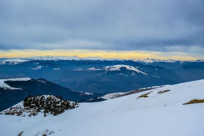 Scenic view of snow covered mountains against sky