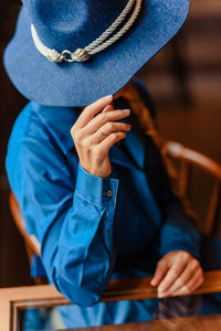 Midsection of man wearing hat