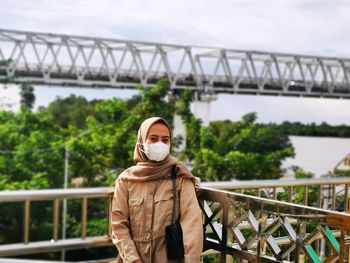 Rear view of woman standing against sky