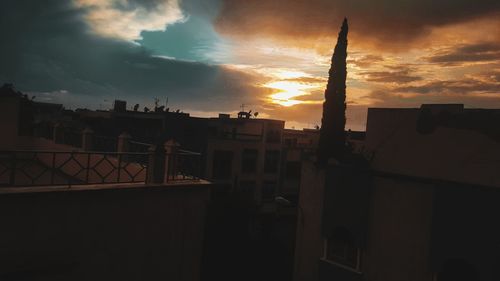 Low angle view of silhouette buildings against sky during sunset