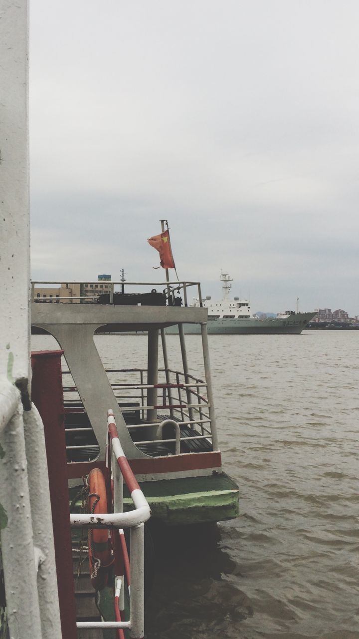 sea, water, lifestyles, leisure activity, sky, rear view, men, sitting, built structure, person, day, relaxation, horizon over water, nautical vessel, architecture, outdoors, pier, boat