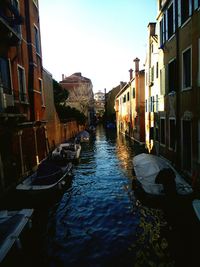 Boats in canal with buildings in background
