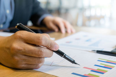 Cropped image of man working on table