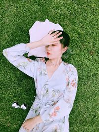 High angle view of woman relaxing on grass