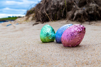 Close-up of multi colored eggs on sand