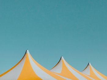 Low angle view of tent against clear blue sky