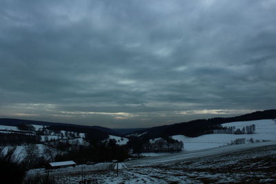 Scenic view of landscape against sky during winter