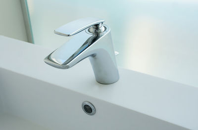 Close-up of faucet in bathroom