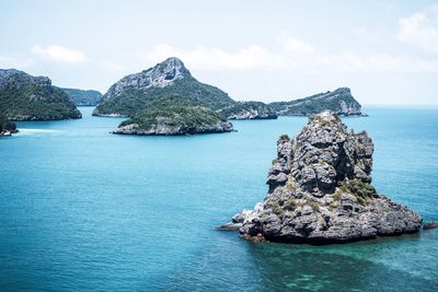 Rock formation in sea against sky