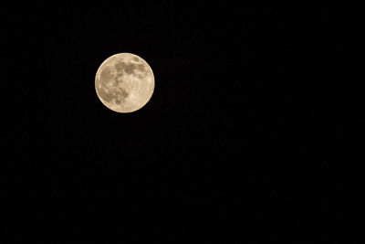 Low angle view of moon against clear sky at night