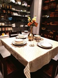 Flower vase on table in restaurant