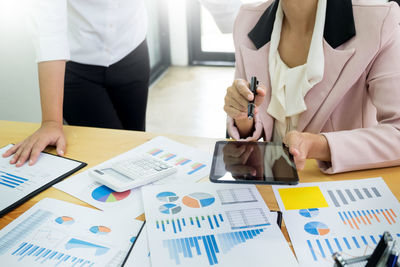 Midsection of woman using mobile phone