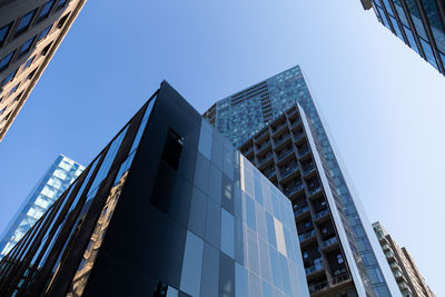 Low angle view of skyscrapers against clear sky