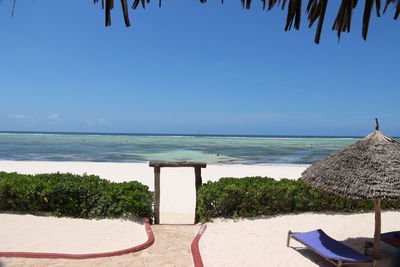 Scenic view of beach against clear blue sky