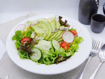 Salad in plate on table