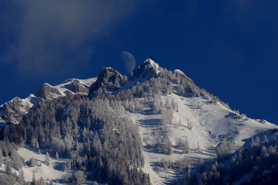 Low angle view of snow mountain against sky