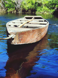 Close-up of boat moored in lake