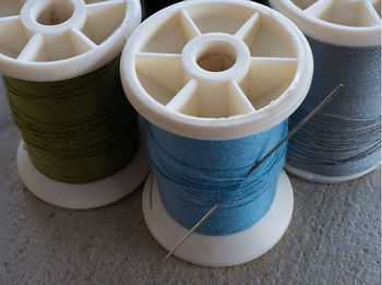 High angle view of spool and needle on table