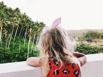 Rear view of woman against sky