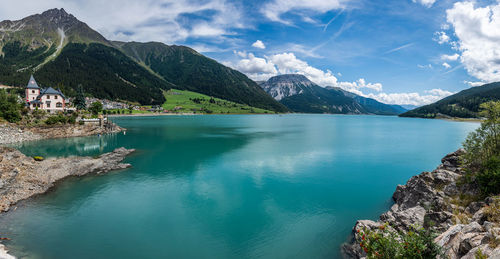 Scenic view of lake and mountains against sky