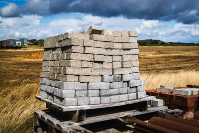 Stone stack on field against sky