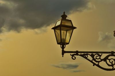 Low angle view of street light against sky at sunset