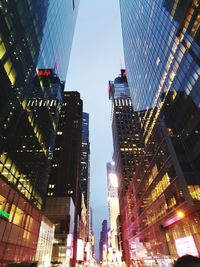 Low angle view of illuminated skyscrapers against sky at night