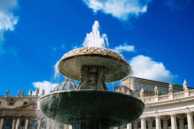 Low angle view of fountain against blue sky