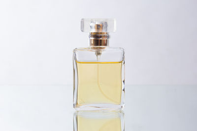 Close-up of glass of bottle against white background