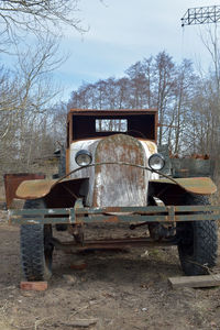 Abandoned truck on field against sky