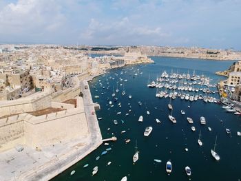 High angle view of townscape by sea against sky