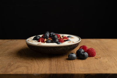 Close-up of breakfast on table against black background