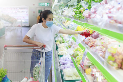 Young woman holding ice cream at store