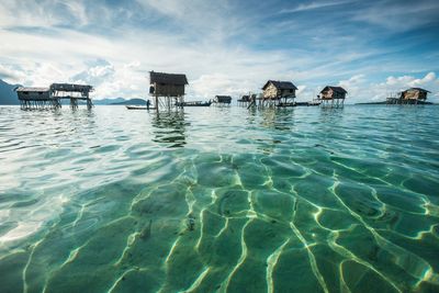 Swimming pool in sea against sky