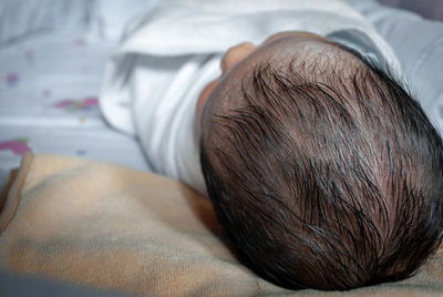 Close-up of man sleeping on bed