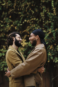 Happy gay person embracing boyfriend