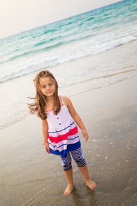 Full length of girl standing on beach