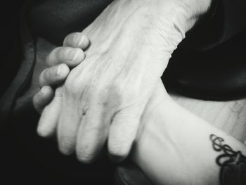 Cropped image of women holding hands