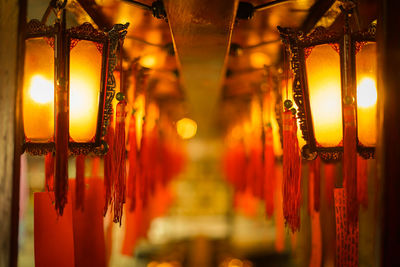 Close-up of illuminated lantern hanging in temple