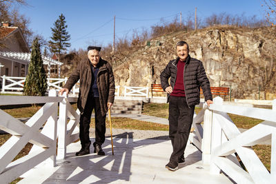 Full length of senior men standing outdoors