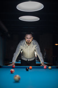 Man playing with ball on table