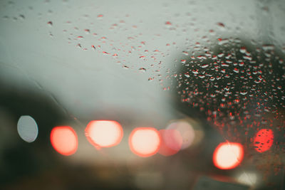 Close-up of wet glass window during rainy season